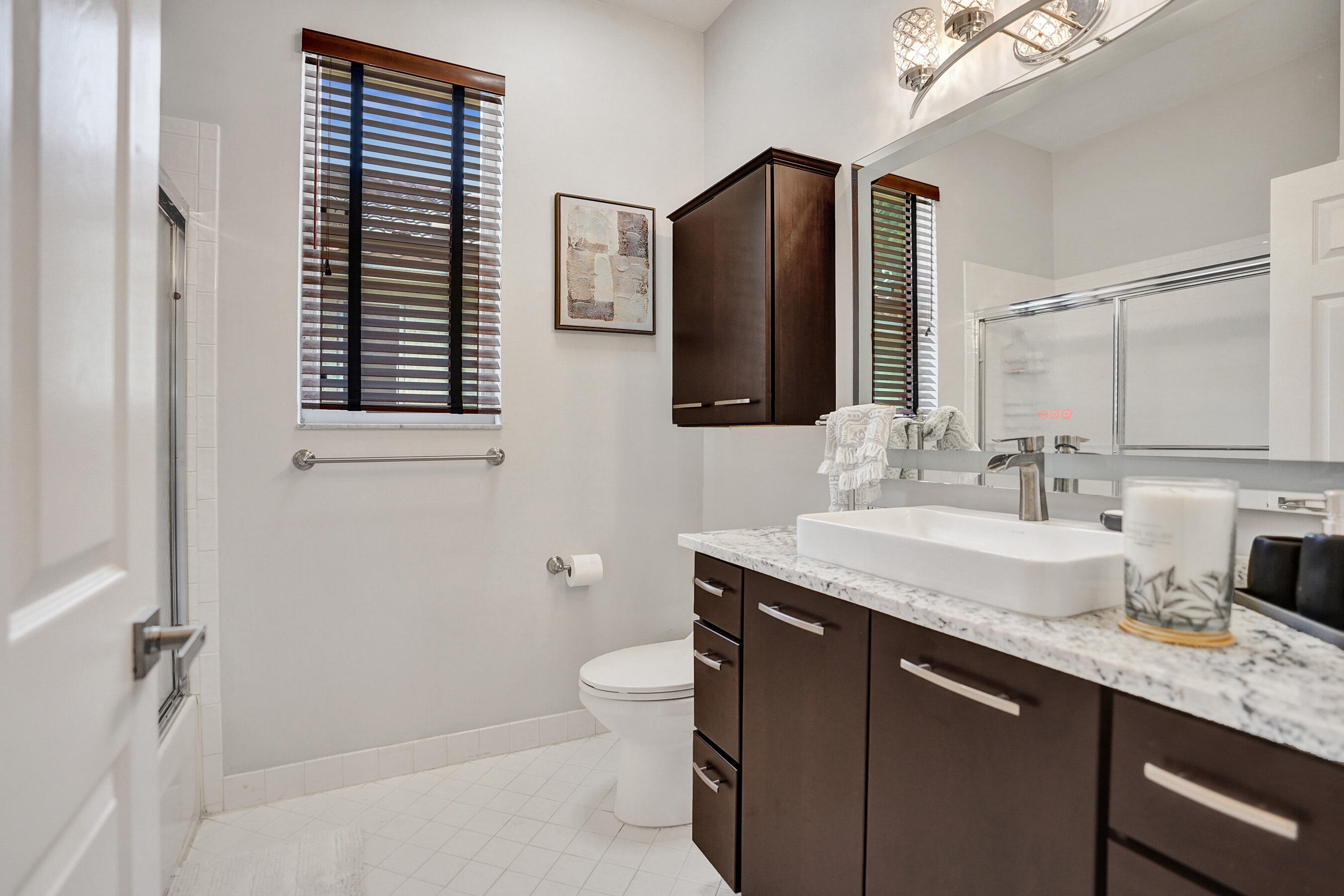 10063 Umberland Place Boca Raton, FL 33428 - Photo 59 of 97 a bathroom with a granite countertop sink toilet and mirror