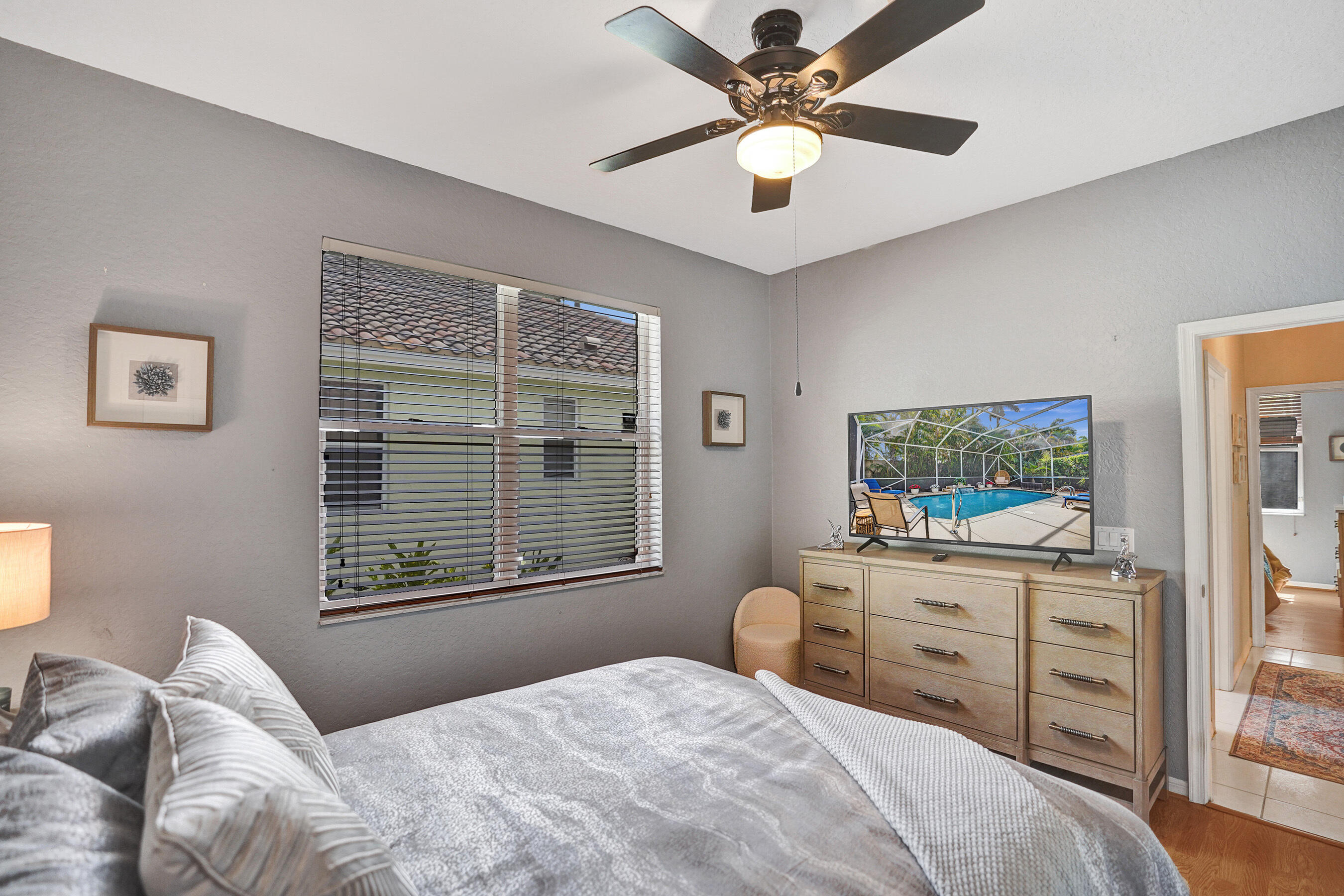 10063 Umberland Place Boca Raton, FL 33428 - Photo 61 of 97 a bedroom with a large bed and a window