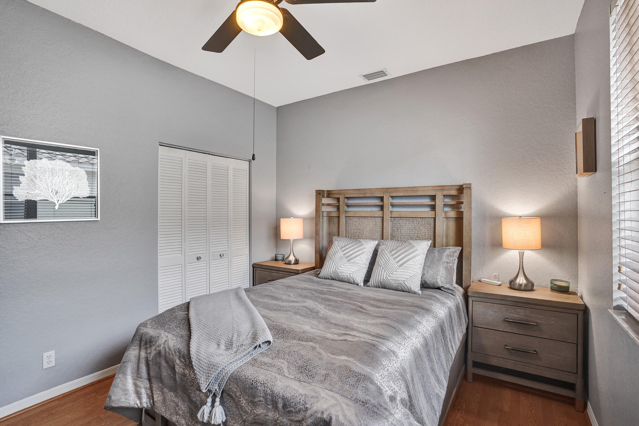 10063 Umberland Place Boca Raton, FL 33428 - Photo 62 of 97 a bedroom with a bed and lamp