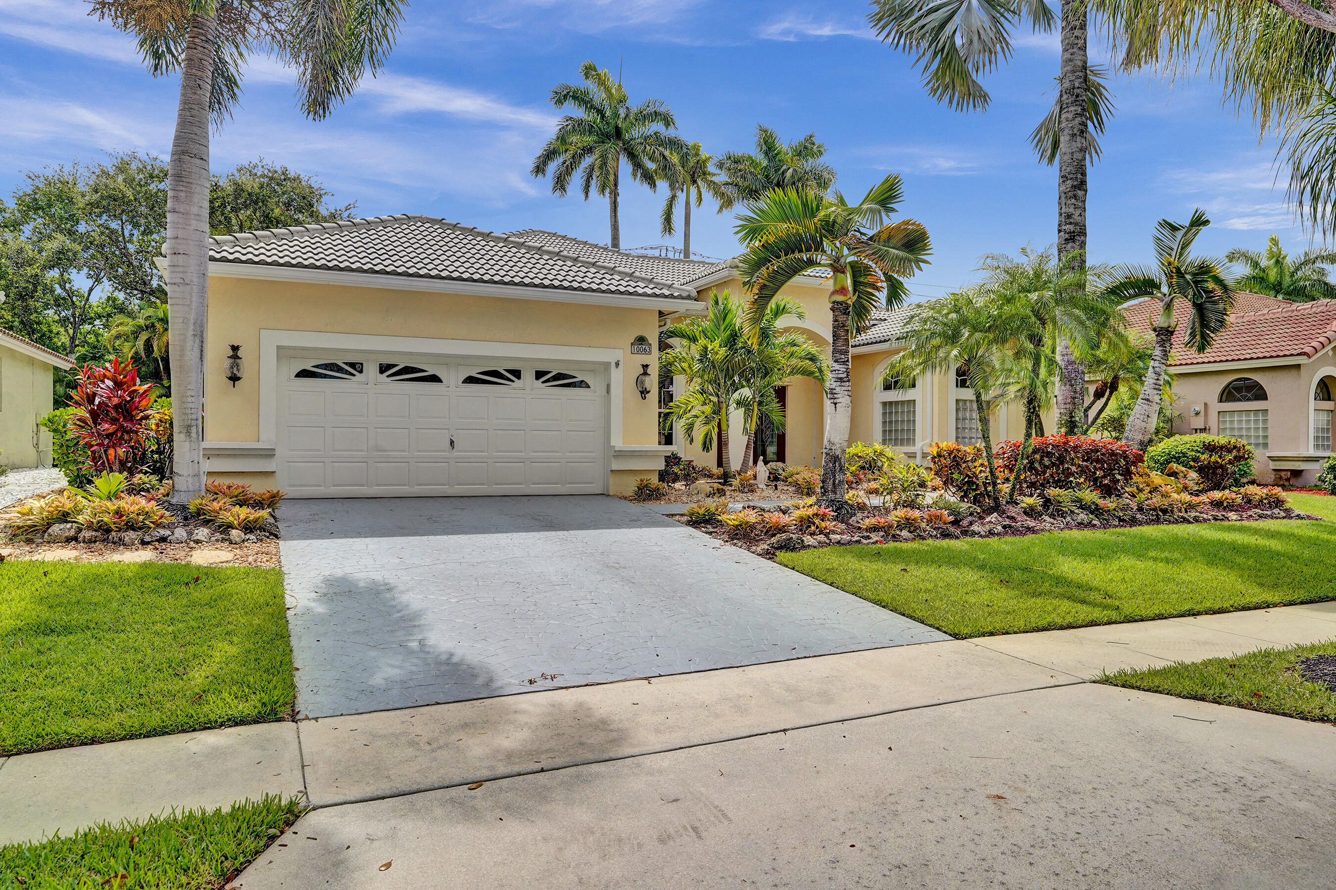 10063 Umberland Place Boca Raton, FL 33428 - Photo 69 of 97 a view of a garage with a yard