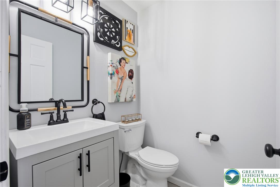 890 Lahr Road Nazareth, PA 18064 - Photo 21 of 71 A clean, compact powder room showcases a stylish vanity and contemporary fixtures.