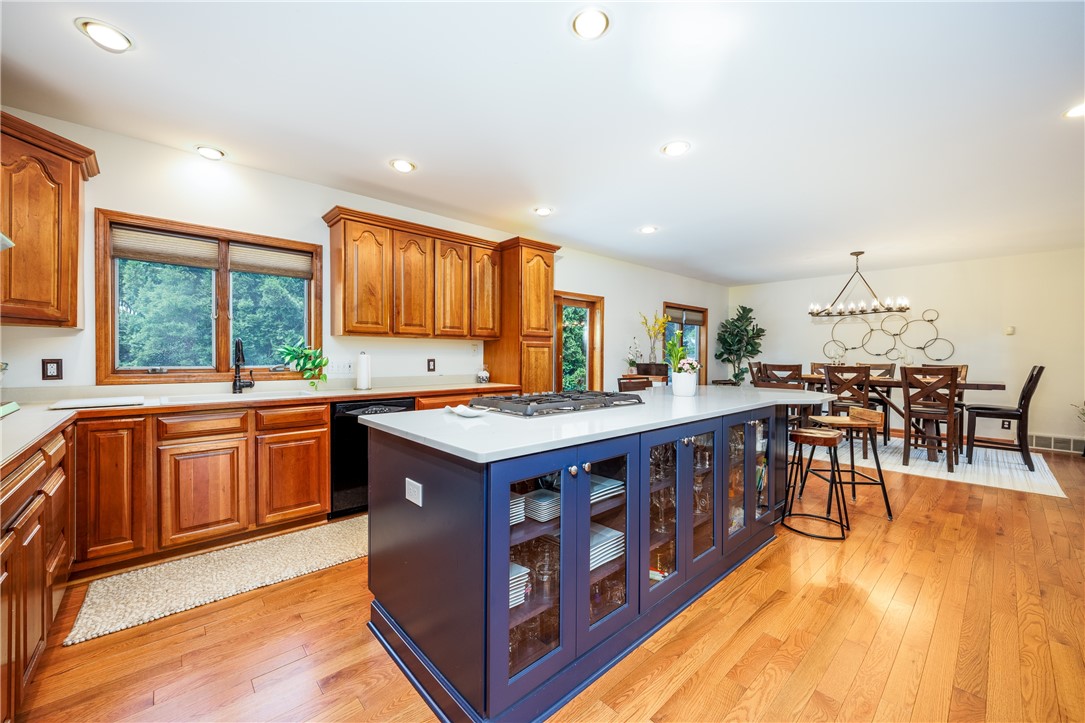 210 Buck Hill Road Greece, NY 14626 - Photo 10 of 49 COOK'S KITCHEN WITH BEAUTIFUL CABINETRY, ISLAND &