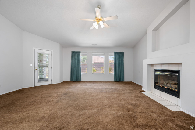 39 North Valley View Drive, Unit 51 St. George, UT 84770 - Photo 8 of 25 Living space featuring a gas fireplace with a tiled hearth and a high vaulted ceiling