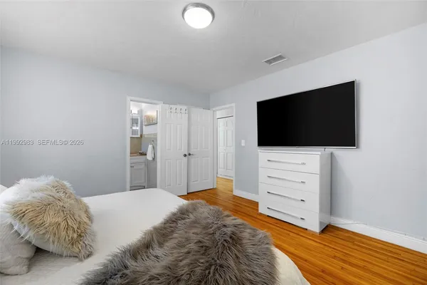 a room with a bed and a mirror