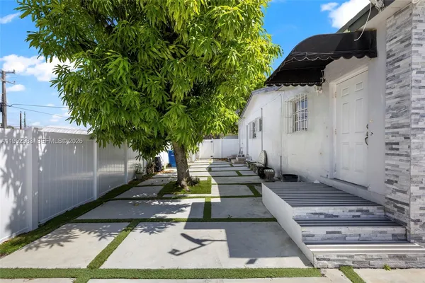 a view of a backyard with sitting area