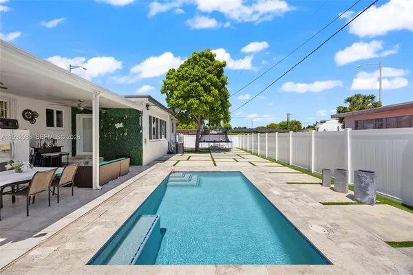 a view of swimming pool with outdoor seating