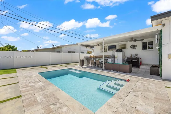 a view of a swimming pool with seating area