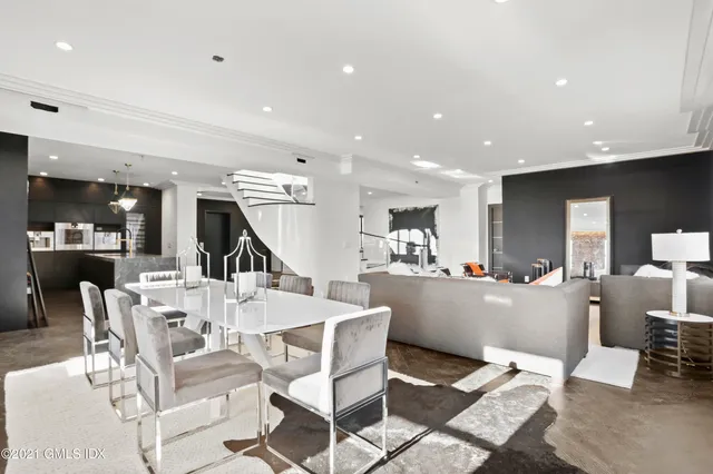 a living room with furniture and kitchen view