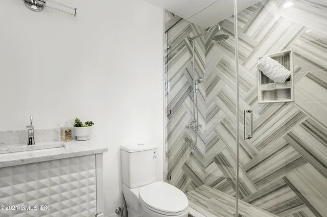 a bathroom with a sink toilet and shower