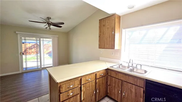 a kitchen with a sink a window and cabinets