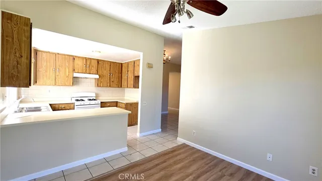 a view of a kitchen with wooden floor and electronic appliances