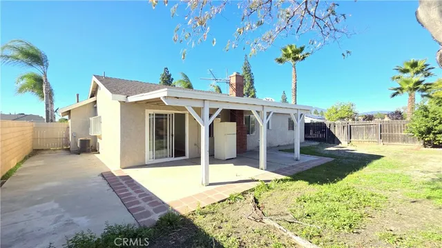 a view of a house with garden and patio