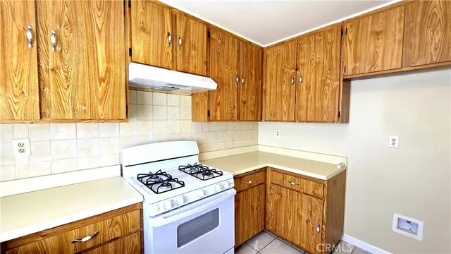 a kitchen with a sink cabinets and a stove top oven