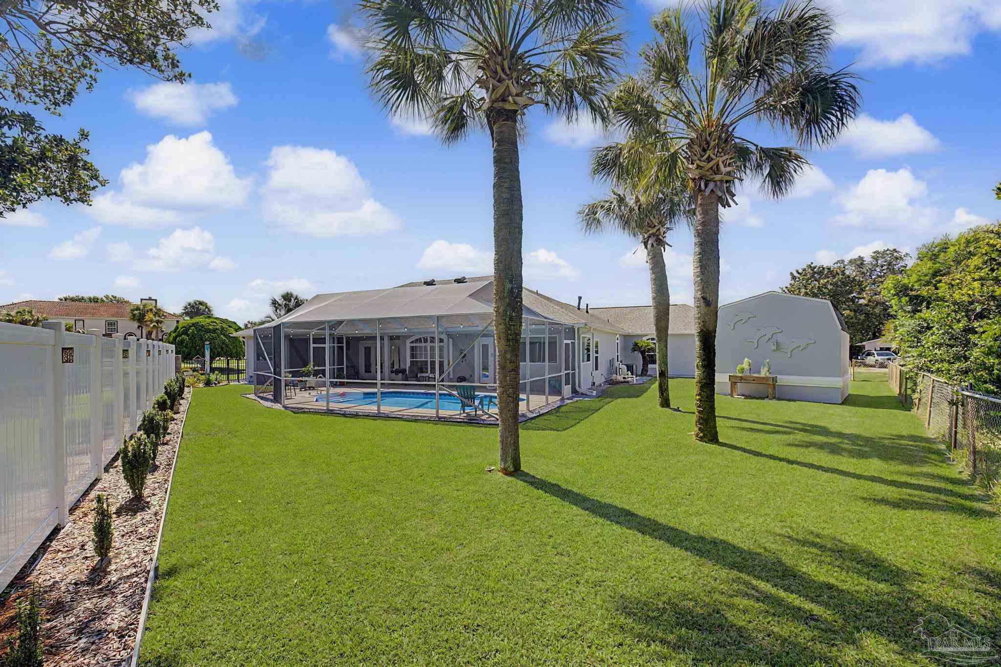 2005 Riviera Lane South Navarre, FL 32566 - Photo 67 of 70 a view of a house with swimming pool and a yard