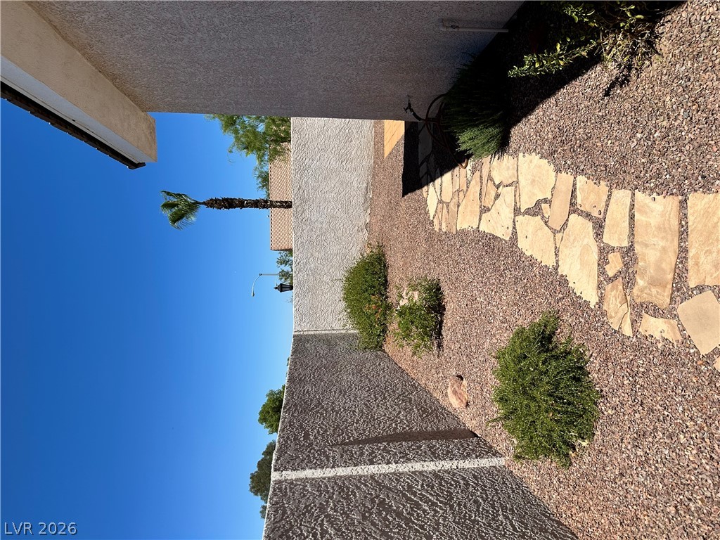1922 Thunder Ridge Circle Henderson, NV 89012 - Photo 24 of 27 A flagstone path winds through a xeriscaped side yard, offering a low-maintenance exterior.