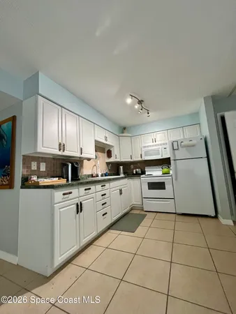 a kitchen with a sink a stove top oven and cabinets