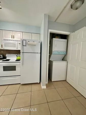 a kitchen with a white cabinets and white appliances