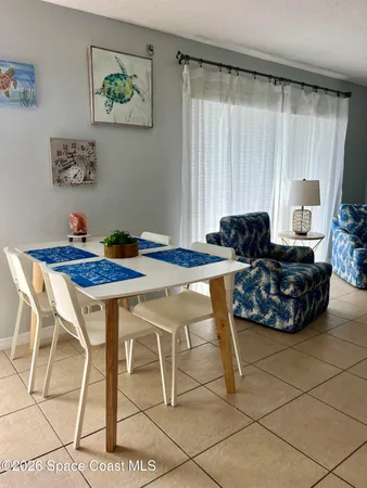 a view of a dining room with furniture and a window