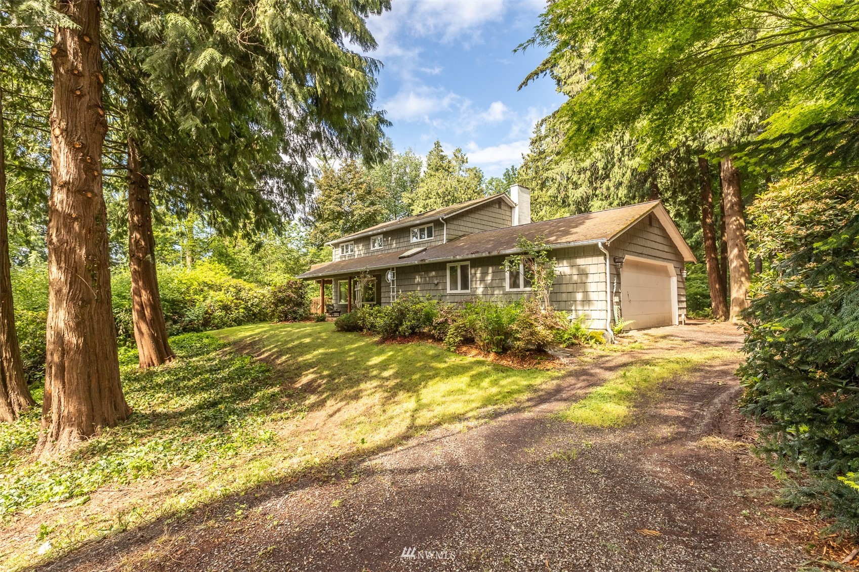 8691 Weidkamp Road Lynden, WA 98264 - Photo 1 of 39 a view of a house with a tree in the background