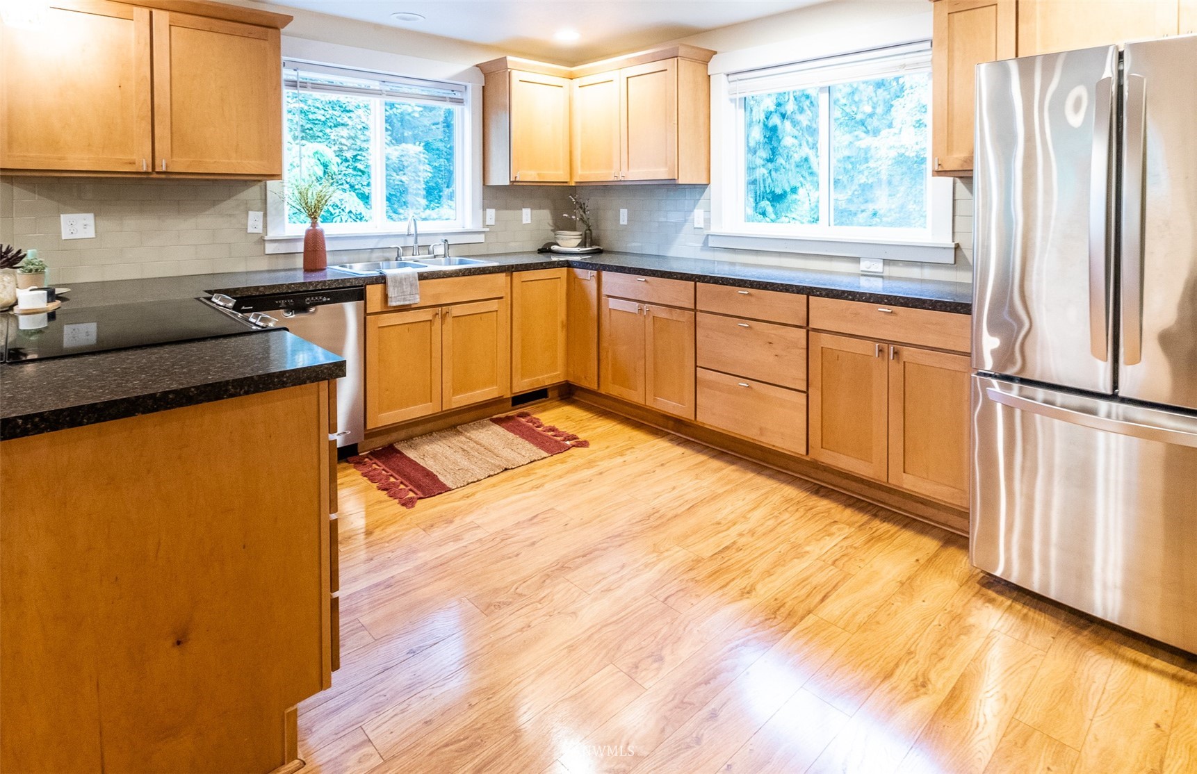 8691 Weidkamp Road Lynden, WA 98264 - Photo 20 of 39 a kitchen with stainless steel appliances granite countertop a refrigerator sink and cabinets
