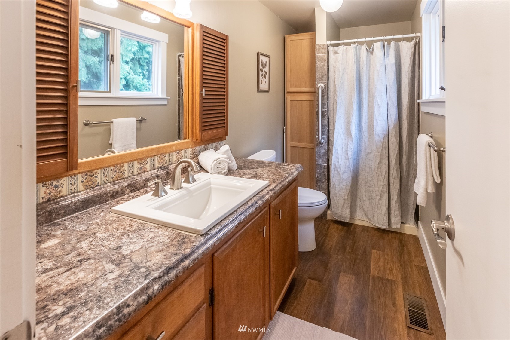 8691 Weidkamp Road Lynden, WA 98264 - Photo 23 of 39 a bathroom with a granite countertop sink and a mirror