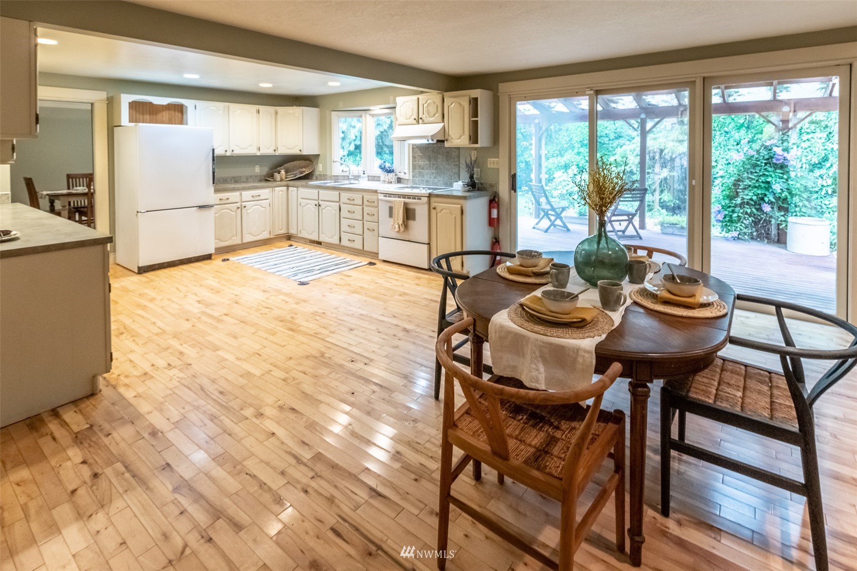 8691 Weidkamp Road Lynden, WA 98264 - Photo 6 of 39 a kitchen with a table chairs and a wooden floor