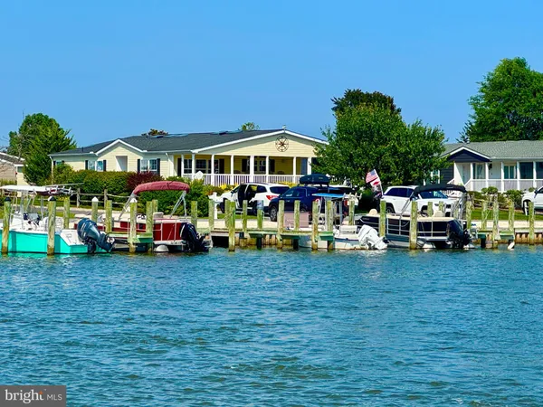 a view of a house with a garden and parked area