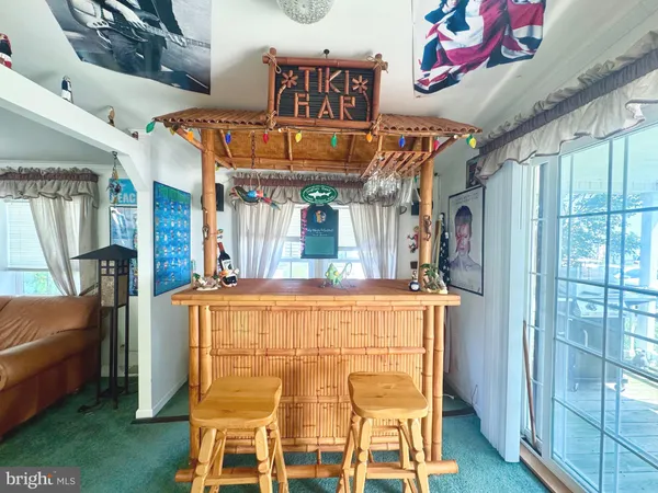 a kitchen with stainless steel appliances kitchen island granite countertop a table and chairs in it