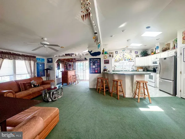 a kitchen with a white stove top oven and refrigerator