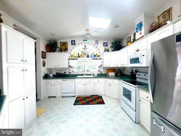a kitchen with stainless steel appliances granite countertop a sink and cabinets