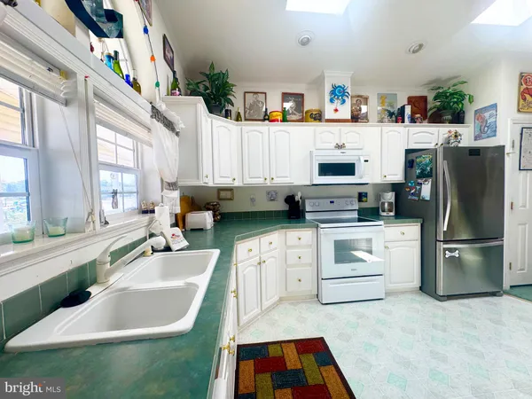 a view of living room with furniture and a kitchen view