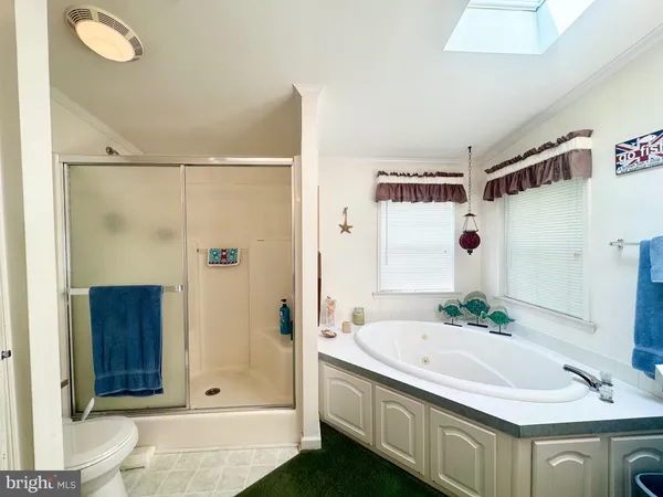 a hallway with two windows and a livingroom