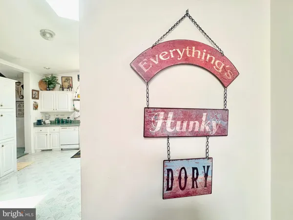 a view of a kitchen with refrigerator and window