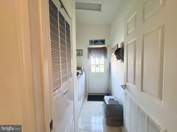 a view of a house with a yard and potted plants