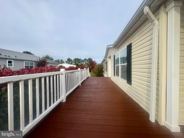 a view of a house with a yard and large trees