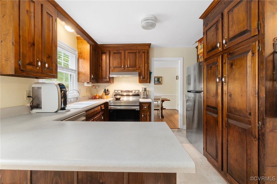 8264 Siege Road Mechanicsville, VA 23111 - Photo 11 of 29 a kitchen with a sink a stove and cabinets