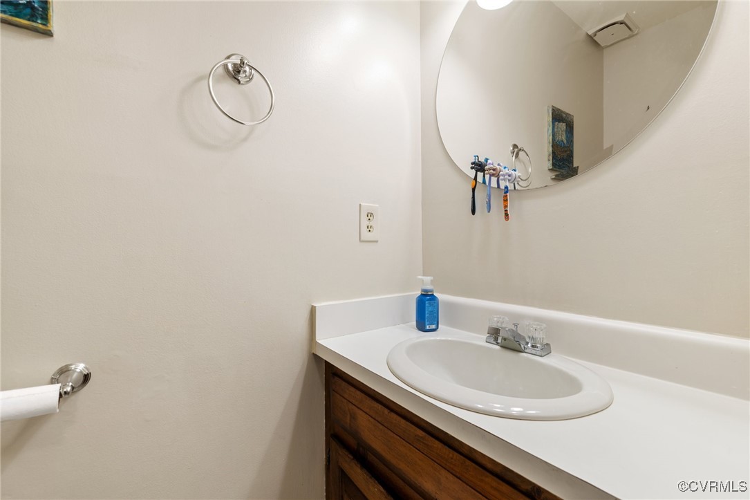 8264 Siege Road Mechanicsville, VA 23111 - Photo 13 of 29 a bathroom with a sink and a mirror