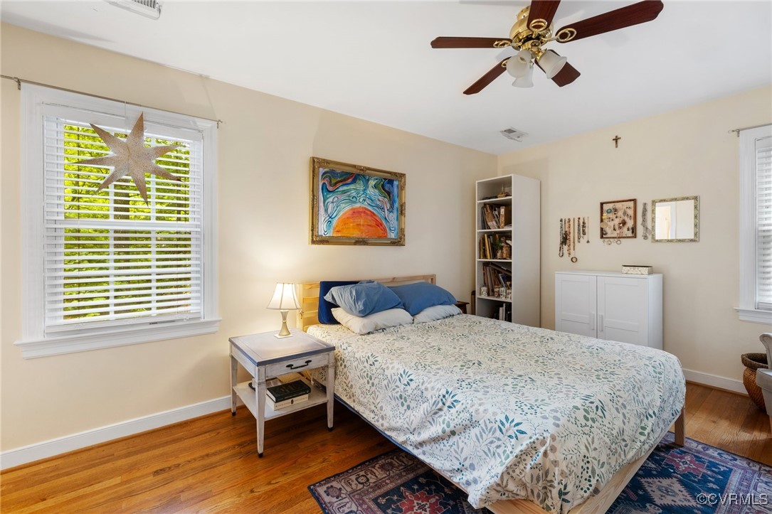 8264 Siege Road Mechanicsville, VA 23111 - Photo 21 of 29 a bedroom with a bed and wooden floor