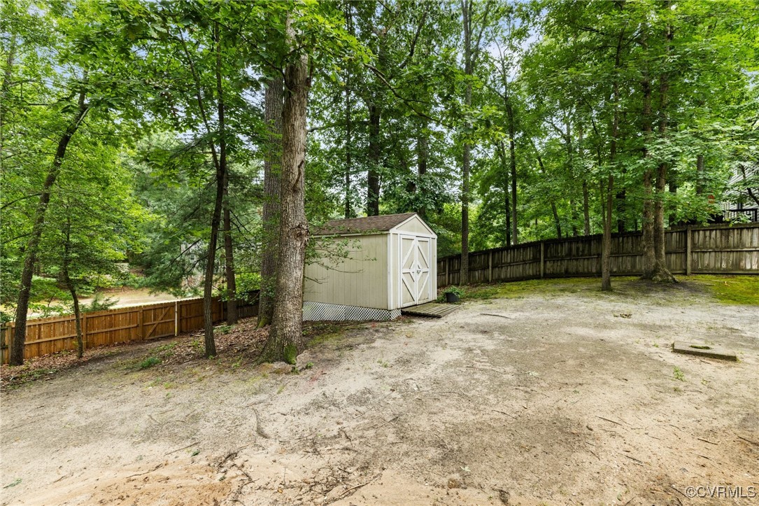 8264 Siege Road Mechanicsville, VA 23111 - Photo 26 of 29 a backyard of a house with a large tree and wooden fence