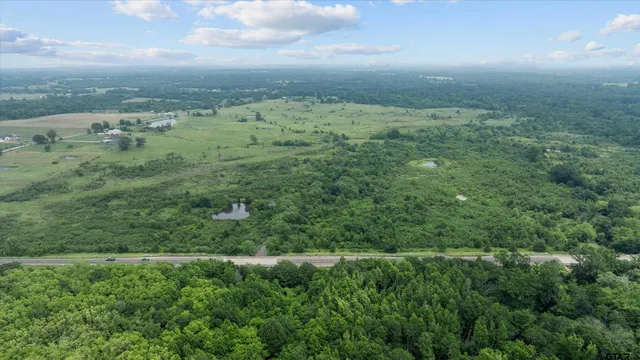 a view of a big yard with lots of green space