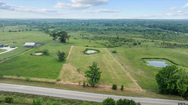 a view of a lake with houses in the back