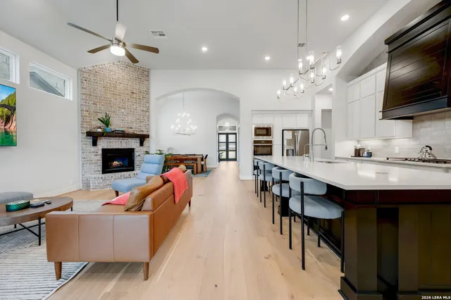 a living room with fireplace furniture and a flat screen tv