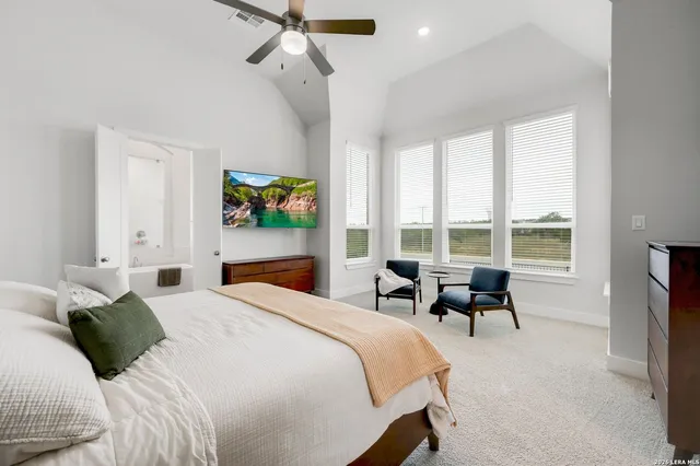 a bedroom with a bed and a large window