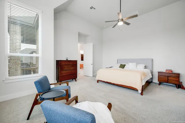 a bedroom with a bed and a chair