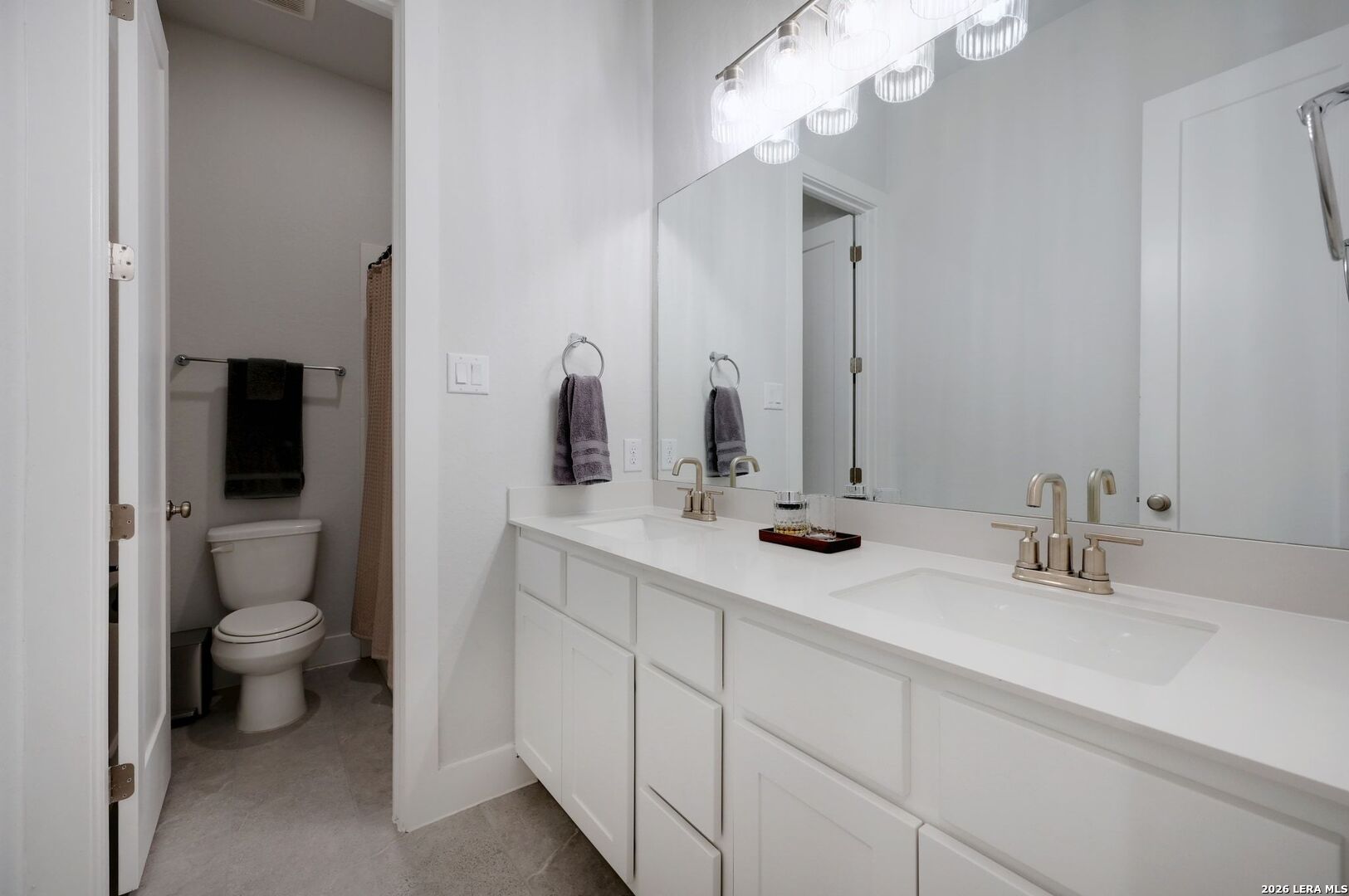 1410 Lytham Bulverde, TX 78163 - Photo 24 of 35 a bathroom with a toilet a sink and mirror