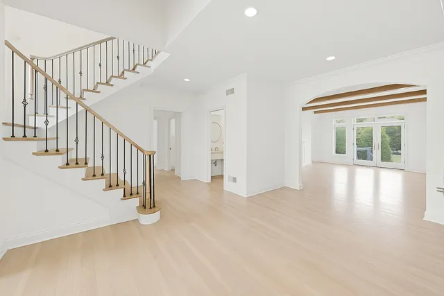 a view of an entryway with wooden floor