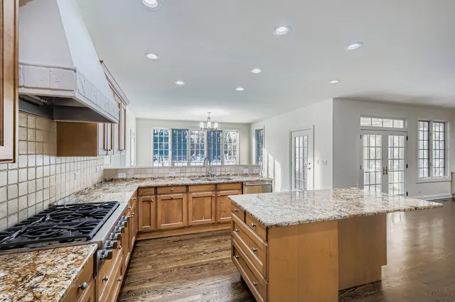a kitchen with stainless steel appliances granite countertop a stove and a sink