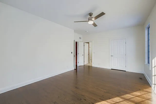 a view of a living room a wooden floor and a fireplace