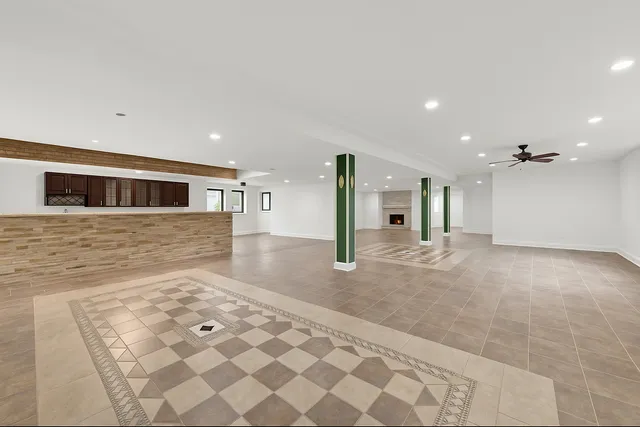 a view of a hallway with wooden floor and a living room