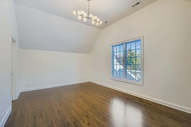a view of a refrigerator in kitchen and a living room